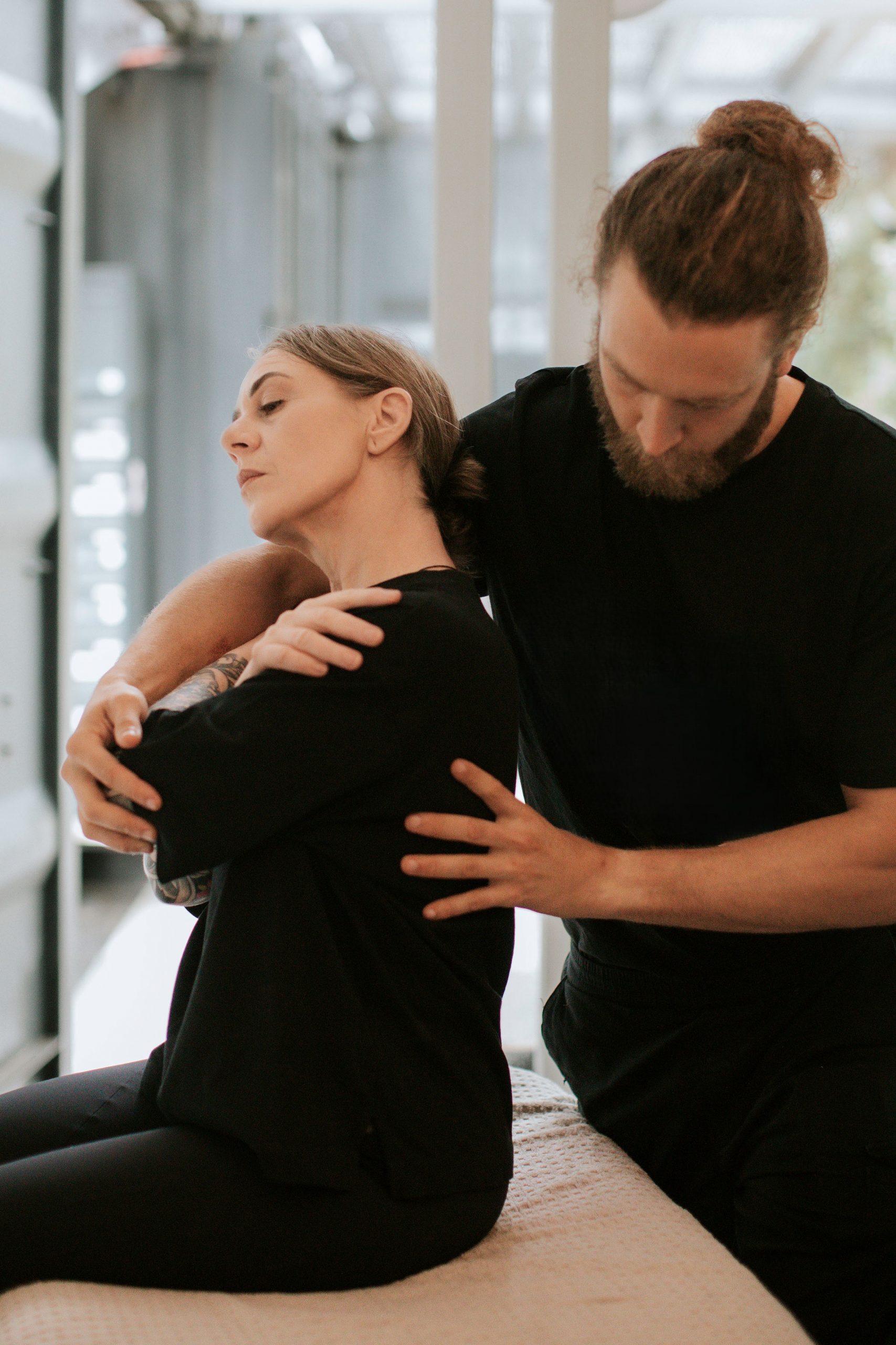 Osteopath providing personalised treatment during a home visit