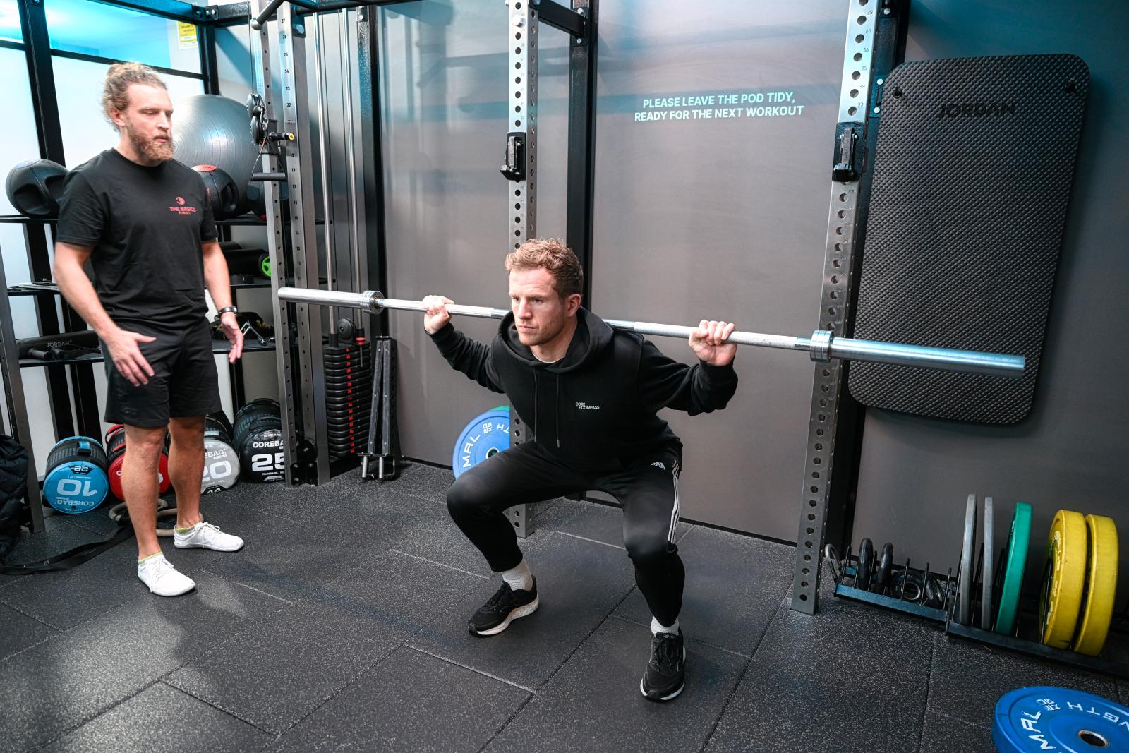 The Basics First coaching a client through a squat